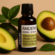 Bottle of 'Ancient Wisdom' avocado oil with avocados and leaves on a beige background