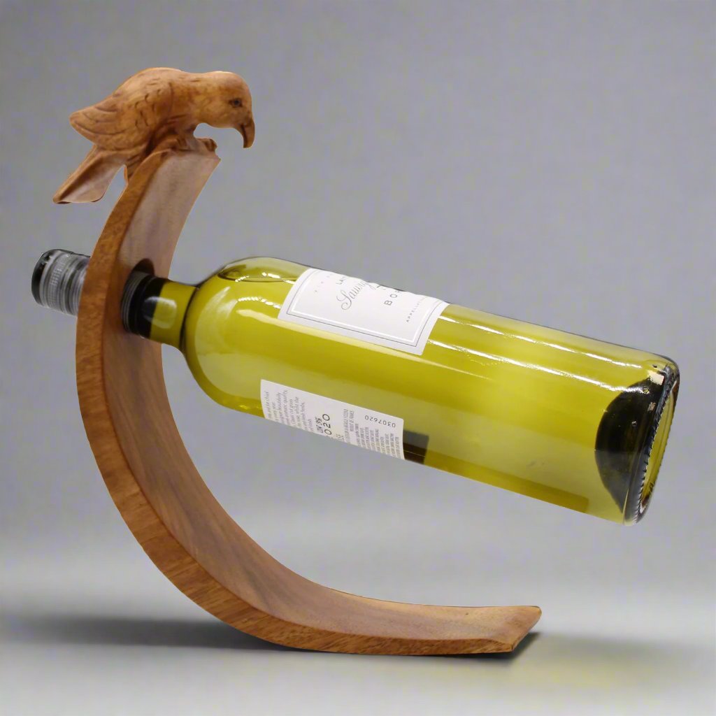 Wooden balance wine holder with carved bird design holding a horizontal wine bottle