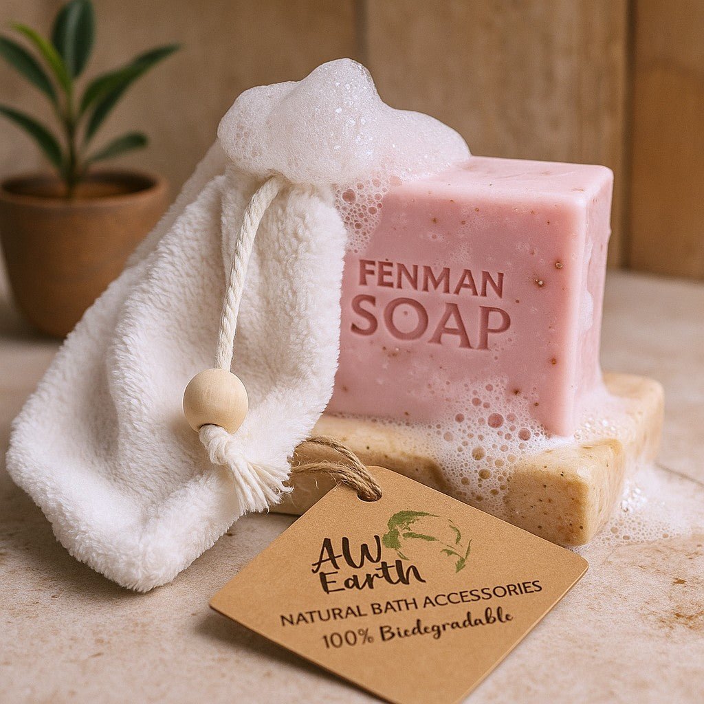 Pink bar of soap with 'Fenman Soap' branding, a white washcloth, and a wooden tag on a neutral background.