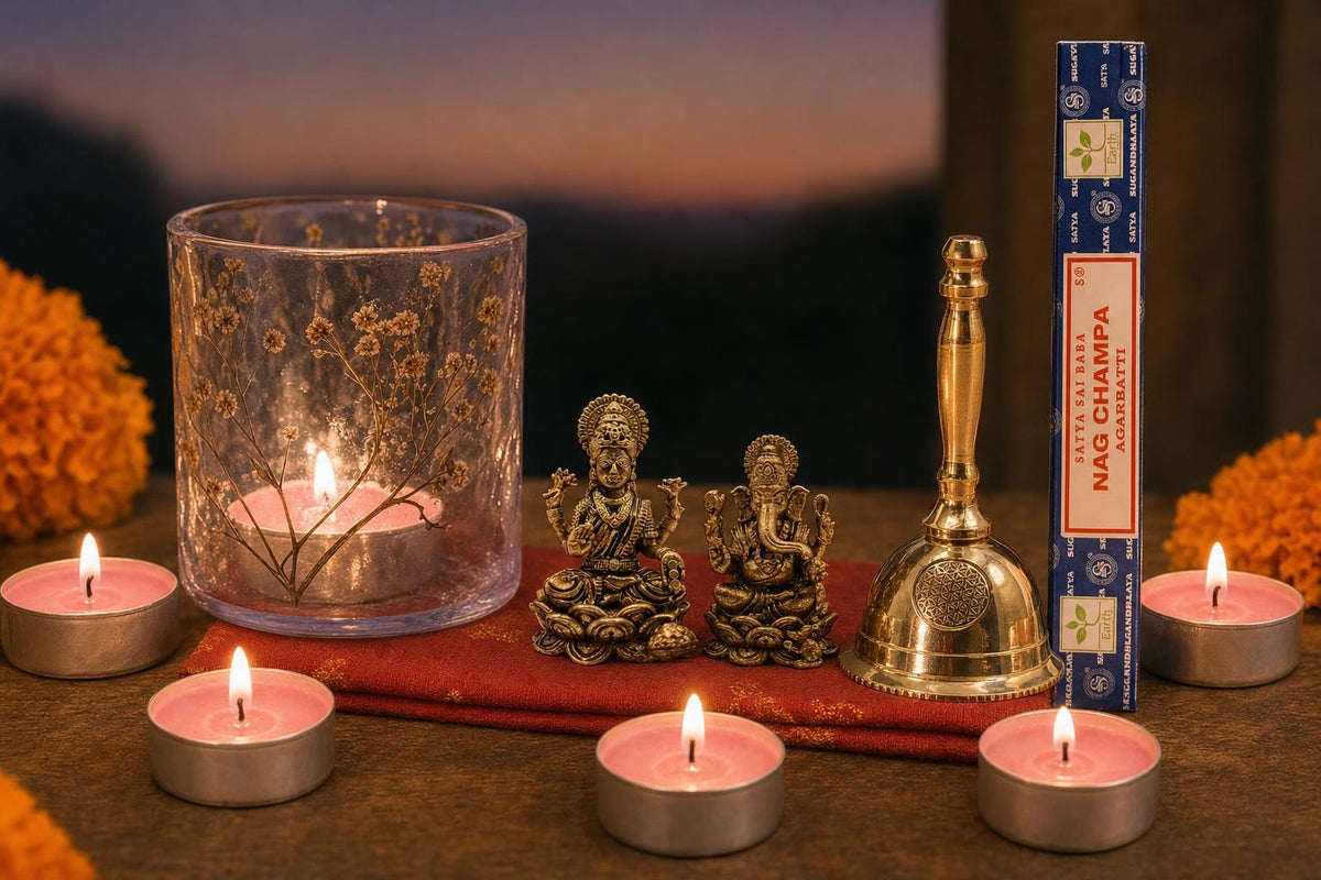 Lakshmi Puja at Home: A Diwali gift for Lakshmi Puja: brass Lakshmi and Ganesha, a small brass bell, a pressed-flower glass lamp with rose tealights, and Satya Nag Champa