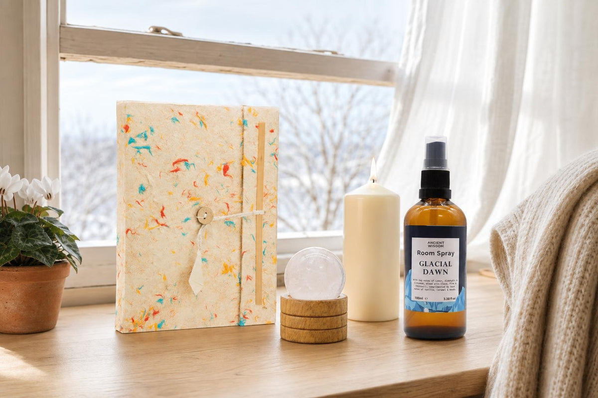 The First Page: A New Year gift: a handmade lokta journal, a clear quartz sphere, an ivory pillar candle and a lemon and pine room spray