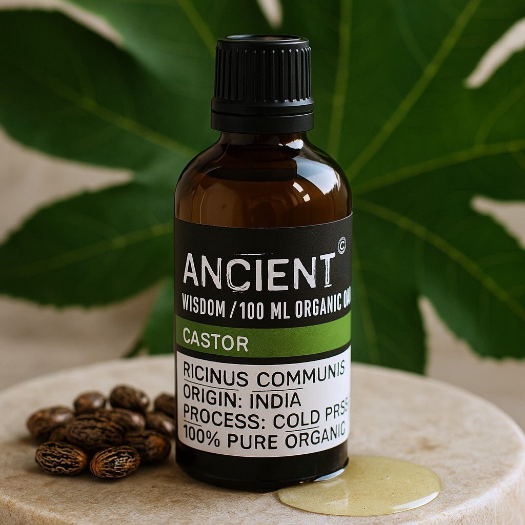 Bottle of Ancient Wisdom castor oil with coffee beans on a stone surface