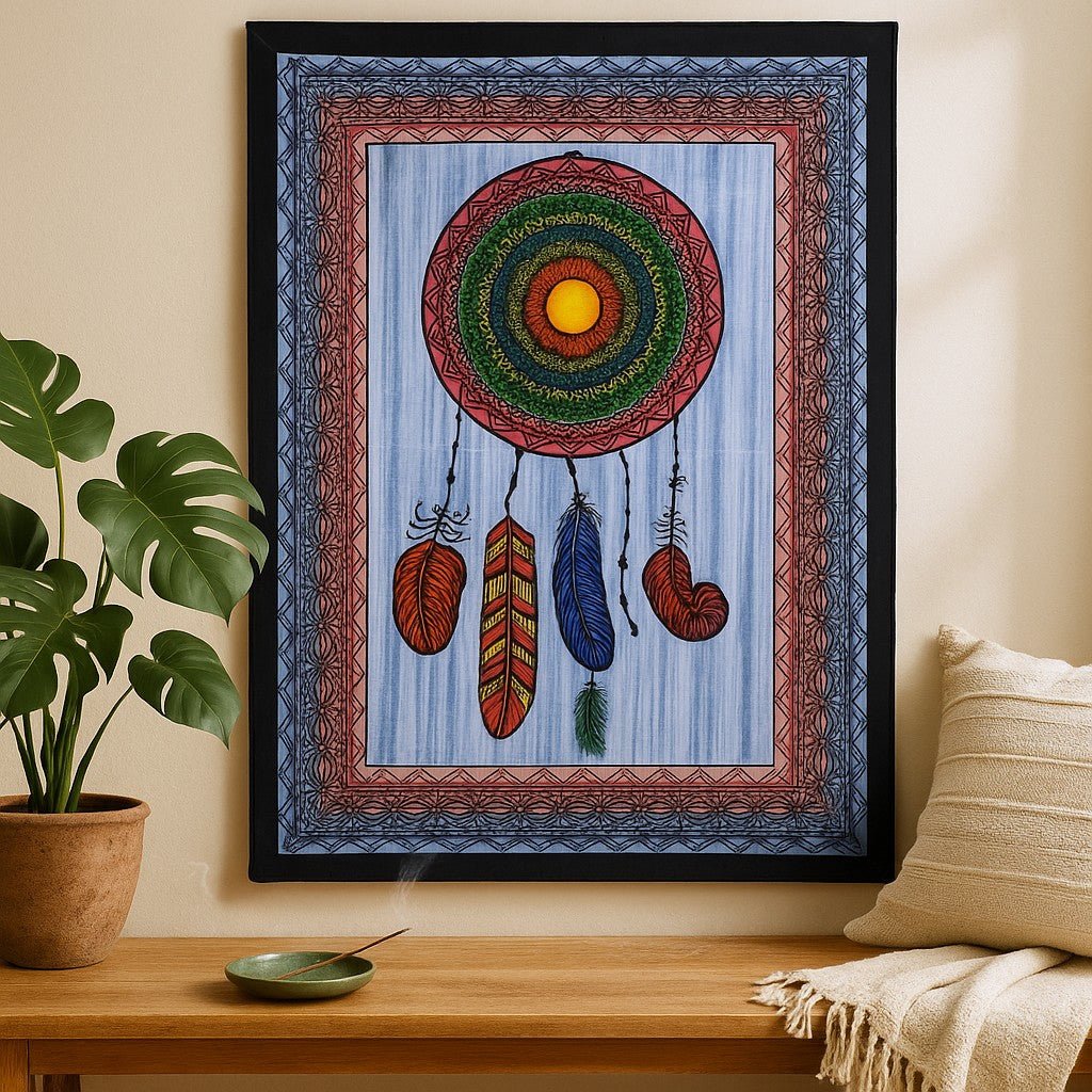 Decorative wall tapestry with a colorful circular design and feathers on a wooden table.