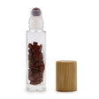 Clear glass roll on bottle filled with polished red jasper stones and wooden cap for essential oils and perfumes