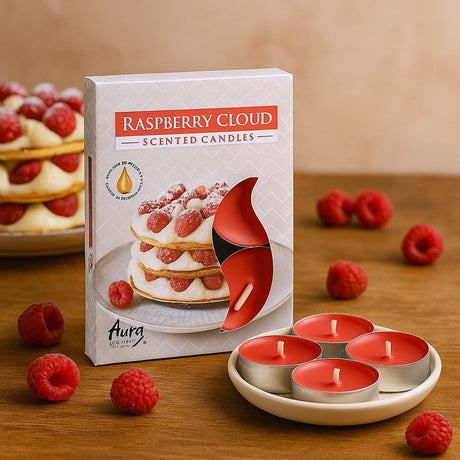 Raspberry cloud scented candles with packaging and raspberries on a wooden surface