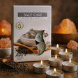 Salt Cave scented candles packaging with lit candles on a wooden surface