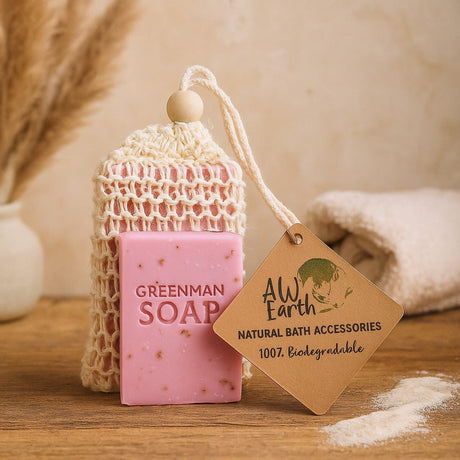 Pink soap bar with a mesh pouch and 'Greenman Soap' branding, displayed on a wooden surface with a 'AW Earth' tag.