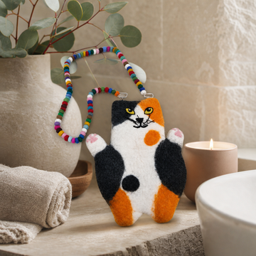 Whitney the Flat Cat Felted Bag — styled in a warm, naturally lit interior