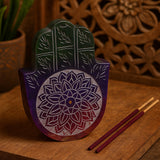 Decorative wooden Hamsa with floral patterns on a wooden surface