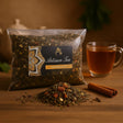 Artisan Tea package with loose tea on a wooden surface