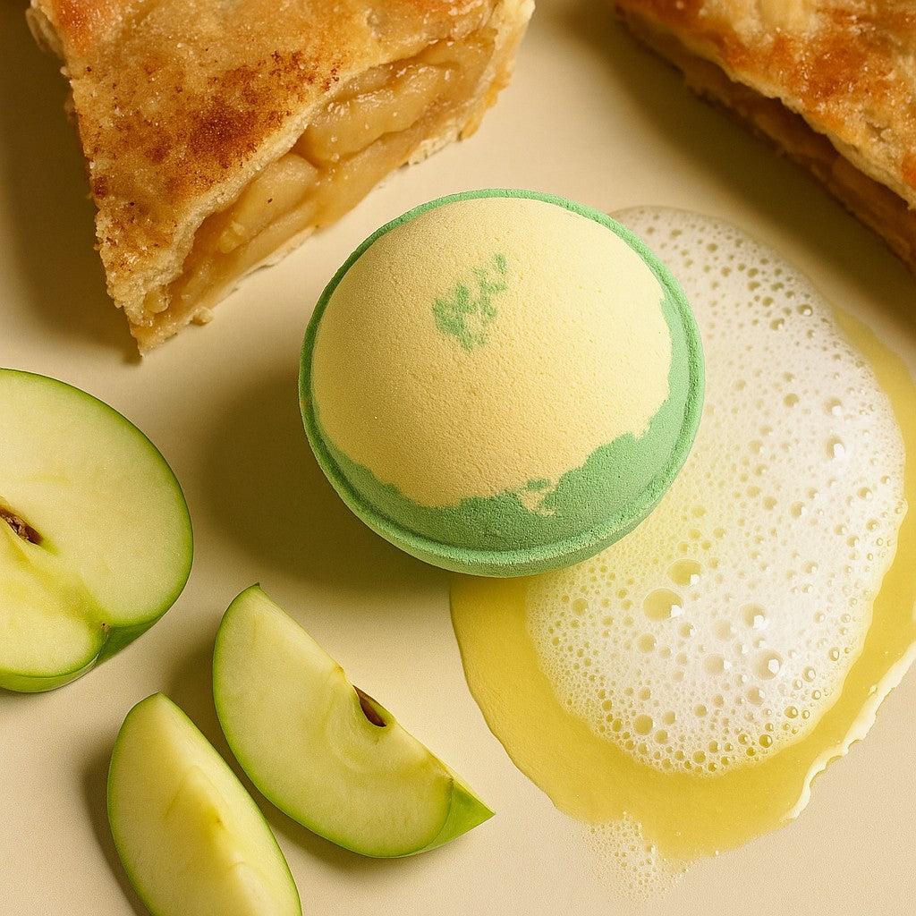 Green bath bomb with foam on a beige surface with apple slices and a pie