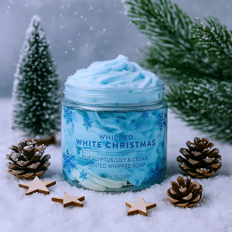 Jar of 'Whipped White Christmas' soap with festive decorations on a snowy background