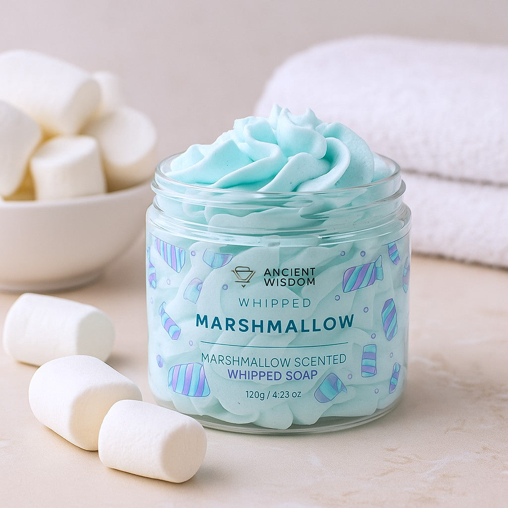 Jar of whipped marshmallow soap with marshmallows and a towel in the background