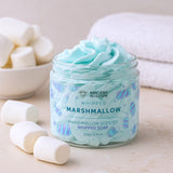 Jar of whipped marshmallow soap with marshmallows and a towel in the background