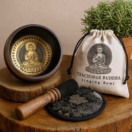 Singing bowl set with Buddha design on a wooden surface