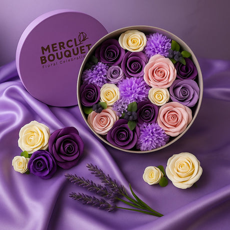 Round box of flowers with 'Merci Bouquet' branding on a purple fabric background