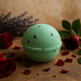Green bath bomb with red rose petals on a wooden surface