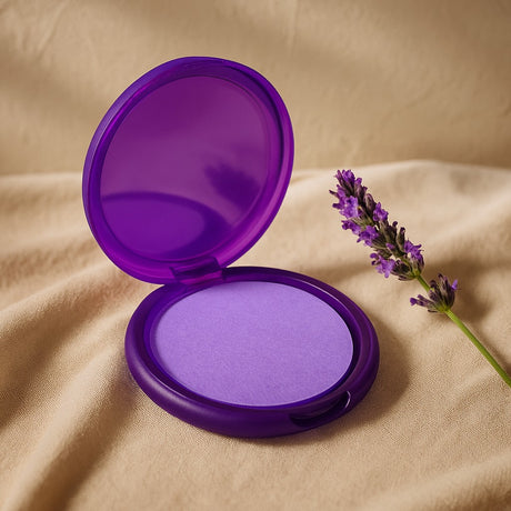 Purple compact powder with a flower on beige fabric