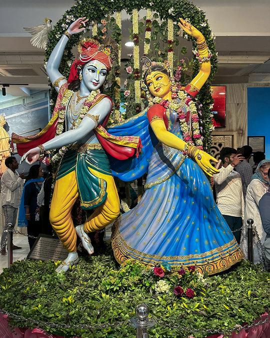 Krishna devotional shrine at the ISKCON temple in Vrindavan, India, dressed with flowers and offerings