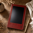 A5 Intention Note Book - LCD Wipe Screen - Red Leather Effect - 80 Leafs — styled in a warm, naturally lit interior
