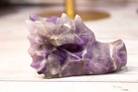 Purple and white crystal rock on a wooden surface
