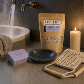 The Long Bath: A bath gift set: lavender Himalayan bath salts, a handmade lavender soap, a black marble soap dish, a jute back scrubber and an ivory candle