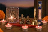 Lakshmi Puja at Home: A Diwali gift for Lakshmi Puja: brass Lakshmi and Ganesha, a small brass bell, a pressed-flower glass lamp with rose tealights, and Satya Nag Champa