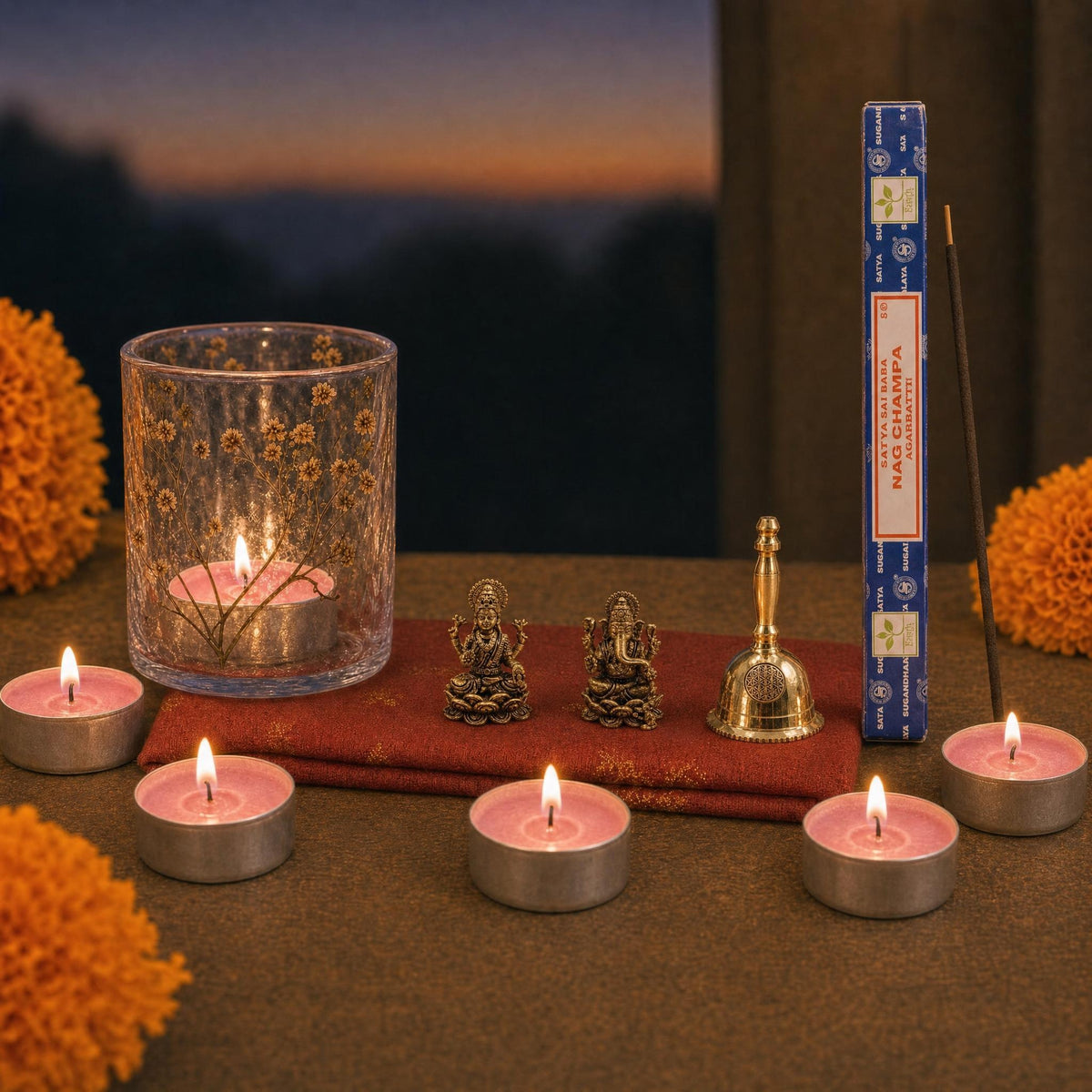 Lakshmi Puja at Home: A Diwali gift for Lakshmi Puja: brass Lakshmi and Ganesha, a small brass bell, a pressed-flower glass lamp with rose tealights, and Satya Nag Champa