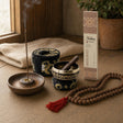 A Corner to Sit In: A meditation gift set: a small brass singing bowl with cushion and stick, hand-rolled sandalwood incense, a mango-wood holder and a rudraksha mala