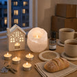 The First Evening Here: A housewarming gift: a white salt tealight holder, a little ceramic house oil burner with cedarwood oil, vanilla tealights and four jute coasters