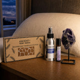 The Last Light Out: A sleep gift set for bedtime: a wheat and lavender eye pillow, a lavender room spray, a lavender, rose and vetiver roll-on and an amethyst on a stand