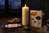 The Longest Night: A winter solstice ritual set: a tall ivory pillar, rosemary incense, a labradorite stone and a pressed-flower notebook