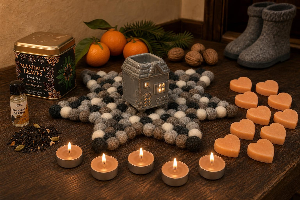 Oranges and Cloves: A St Nicholas gift in orange and clove: a townhouse oil burner on a felt star, cinnamon and orange oil, cinnamon tealights, orange soap hearts and a spiced tea with cloves