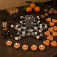 Oranges and Cloves: A St Nicholas gift in orange and clove: a townhouse oil burner on a felt star, cinnamon and orange oil, cinnamon tealights, orange soap hearts and a spiced tea with cloves