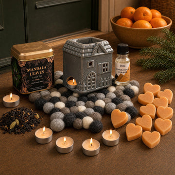 Oranges and Cloves: A St Nicholas gift in orange and clove: a townhouse oil burner on a felt star, cinnamon and orange oil, cinnamon tealights, orange soap hearts and a spiced tea with cloves