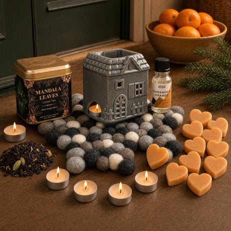 Oranges and Cloves: A St Nicholas gift in orange and clove: a townhouse oil burner on a felt star, cinnamon and orange oil, cinnamon tealights, orange soap hearts and a spiced tea with cloves