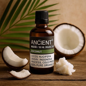 Bottle of Ancient coconut oil with coconuts and palm leaves on a wooden surface
