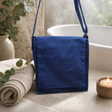 Cotton Canvas Messenger Bag - Navy Blue — styled in a warm, naturally lit interior