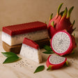 Dragon fruit and soap bars on a wooden surface