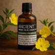 Bottle of Ancient Wisdom organic evening primrose oil with yellow flowers on a wooden surface