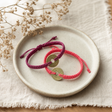 Handmade Friendship Bracelets - Lucky Friends Feng Shui Coin — styled in a warm, naturally lit interior