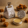 Salted caramel product with packaging and tins on a textured surface