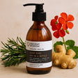 Brown bottle of 'Joint Ease Spa in a Bottle' massage bath oil by Ancient Wisdom with ginger root and flowers on a beige background.