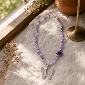 Nymph Amethyst Gemstone Necklace with Real Leaf Butterfly Pendant — styled in a warm, naturally lit interior