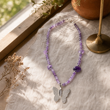 Nymph Amethyst Gemstone Necklace with Real Leaf Butterfly Pendant — styled in a warm, naturally lit interior