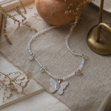 Nymph Labradorite Gemstone Necklace with Real Leaf Butterfly Pendant — styled in a warm, naturally lit interior
