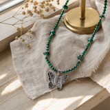 Nymph Malachite Gemstone Necklace with Real Leaf Butterfly Pendant — styled in a warm, naturally lit interior