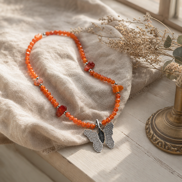 Nymph Ruby Gemstone Necklace with Real Leaf Butterfly Pendant — styled in a warm, naturally lit interior