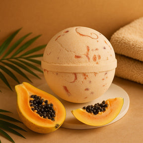 Bath bomb with a papaya and leaf on a beige background