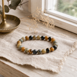 Petite Power Bracelet (17cmx6mm) - Dream Tigereye — styled in a warm, naturally lit interior